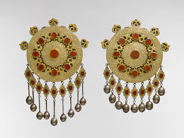 Pectoral Disc Ornament, One of a Pair, Silver; fire-gilded with engraving/punching, stylized floral terminations, openwork decoration, pendants, silver twisted wire chains, table cut carnelians, and bells/beads 