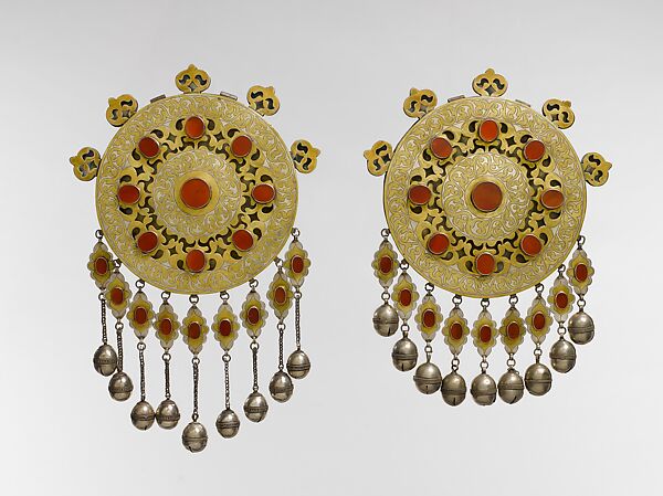 Pectoral Disc Ornament, One of a Pair, Silver; fire-gilded with engraving/punching, stylized floral terminations, openwork decoration, pendants, silver twisted wire chains, table cut carnelians, and bells/beads. 