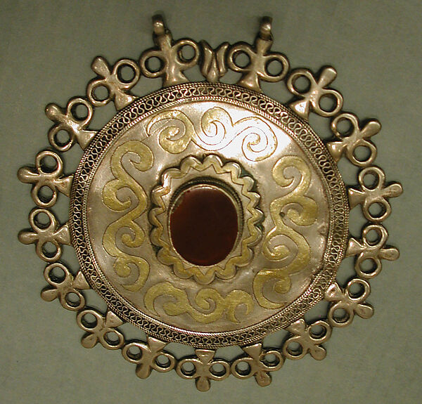 Pectoral Disc Ornament, Silver; fire-gilded and chased with rams head terminals, decorative wire and table cut carnelian