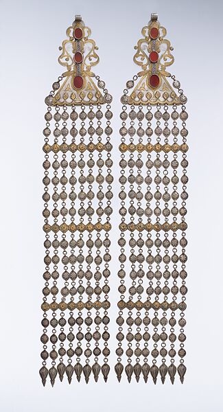 Long Temple Pendant, One of a Pair, Silver; fire-gilded and chased, with decorative wire, applied and openwork decoration, connecting links with applied decoration, embossed pendants, and table-cut carnelians 