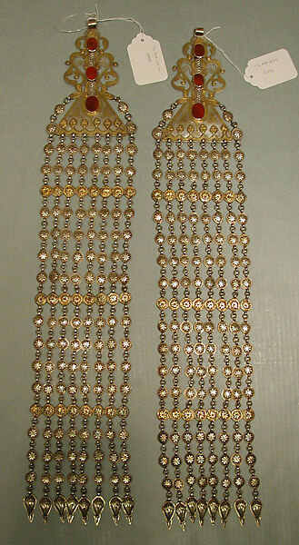 Long Temple Pendant, One of a Pair, Silver, fire-gilded and chased, with decorative wire, applied and openwork decoration, connecting links with applied decoration, embossed pendants, and table-cut carnelians