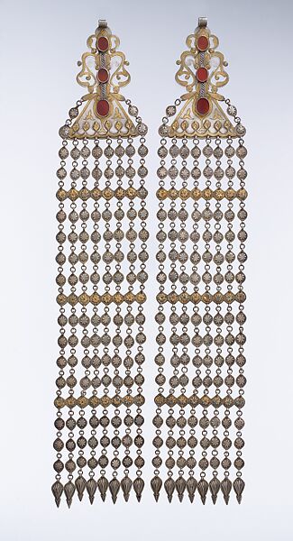 Long Temple Pendant, One of a Pair, Silver, fire-gilded and chased, with decorative wire, applied and openwork decoration, connecting links with applied decoration, embossed pendants, and table-cut carnelians 