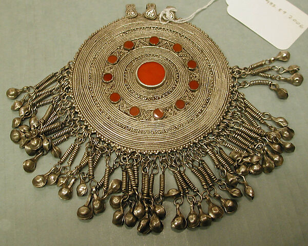 Pectoral Disc Ornament, Silver, with decorative wire, stamped beading, silver shot, applied decoration, chains, bells, and table-cut carnelians