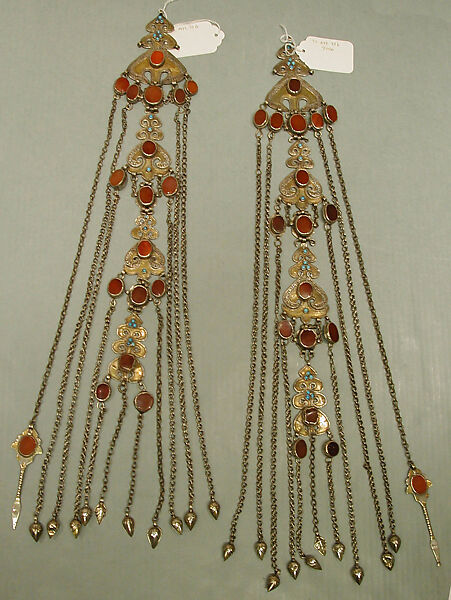 Temple Pendant, One of a Pair, Silver; fire-gilded, with decorative wire, table-cut carnelians, glass stones, turquoise beads, loop-in- loop chains, and embossed pendants