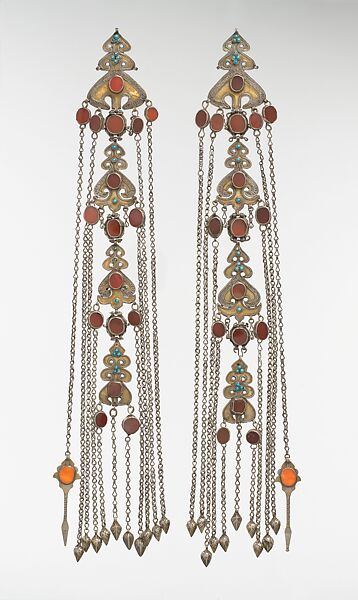Temple Pendant, One of a Pair, Silver; fire-gilded, with decorative wire, table-cut carnelians, glass stones, turquoise beads, loop-in- loop chains, and embossed pendants