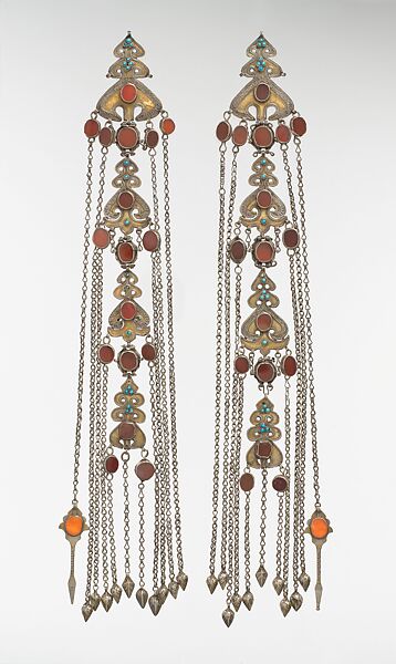 Temple Pendant, One of a Pair, Silver; fire-gilded, with decorative wire, table-cut carnelians, glass stones, turquoise beads, loop-in- loop chains, and embossed pendants 