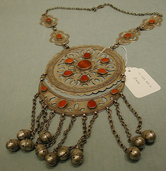 Pectoral Disc Ornament, One of a Pair, Silver; fire gilded with openwork decorations, table cut carnelians, silver twisted wire and link chains, and bells/beads