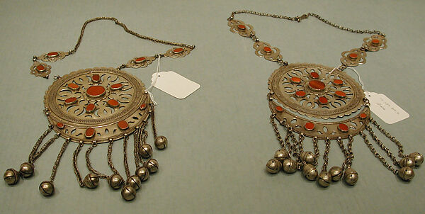 Pectoral Disc Ornament, One of a Pair, Silver; fire gilded with openwork decorations, table cut carnelians, silver twisted wire and link chains, and bells/beads