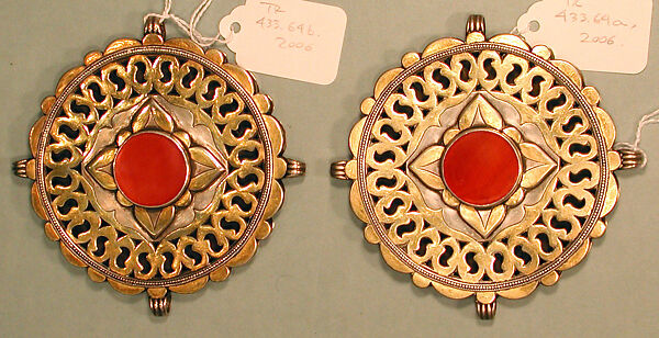 Pectoral Disc Ornament, One of a Pair, Silver; fire-gilded with stamped bead and twisted wired decoration, engraving/punching and openwork decoration and table cut carnelian