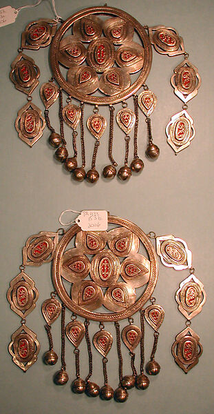 Pair of Pectoral Ornaments, Silver; with false granulation stamped and bead decoration, glass or colored stones, silver link chains, and bells/beads