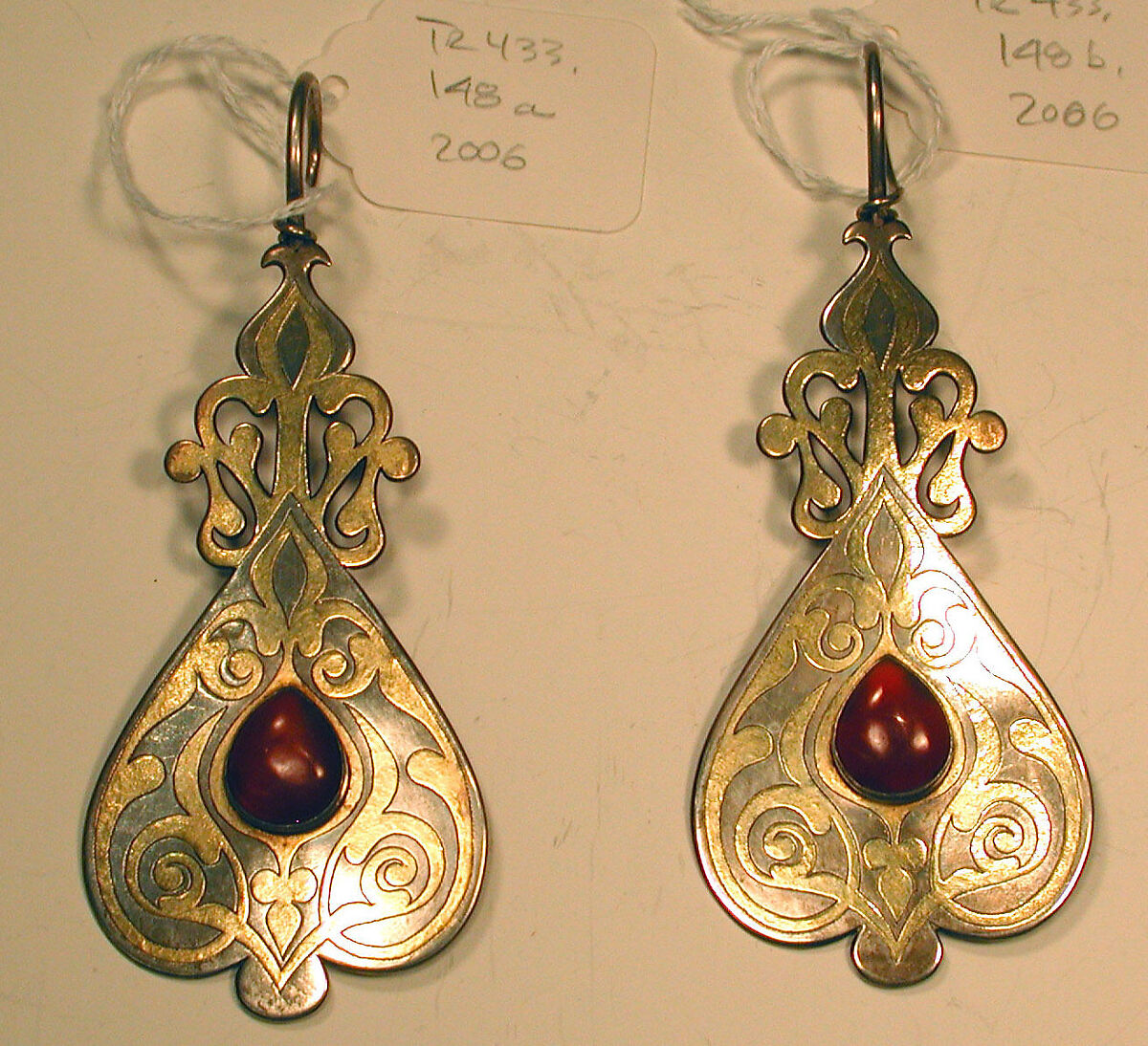 Short Temple Pendant, One of a Pair, Silver; fire-gilded and chased, with openwork and cabochon carnelians