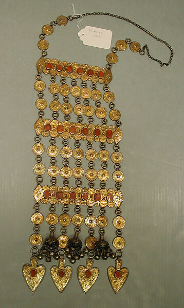 Dorsal Plait Ornament, Silver; fire-gilded with stamped and applique decoration, table cut carnelians, Persian silver coins, loop-in-loop chains, and semi-spherical bells
