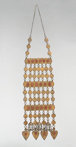 Dorsal Plait Ornament, Silver; fire-gilded with stamped and applique decoration, table cut carnelians, Persian silver coins, loop-in-loop chains, and semi-spherical bells 