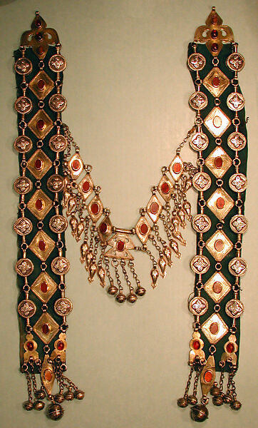 Dorsal Plait Ornament, Silver, fire-gilded and engraved/punched with stamped, beaded and applique decoration and table cut carnelians and slightly domed carbelians with silver link chains, bells/beads and embossed pendants