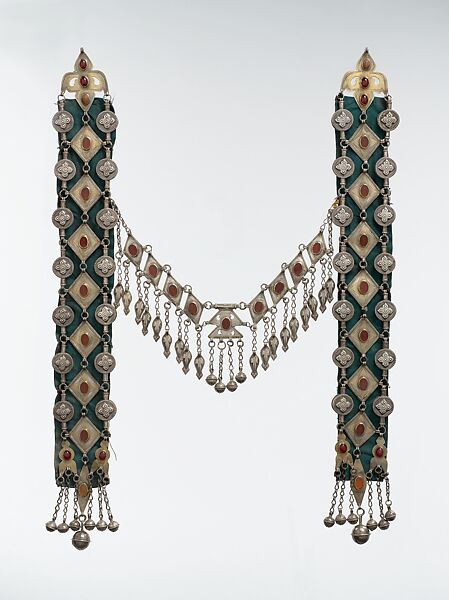 Dorsal Plait Ornament, Silver, fire-gilded and engraved/punched with stamped, beaded and applique decoration and table cut carnelians and slightly domed carbelians with silver link chains, bells/beads and embossed pendants 
