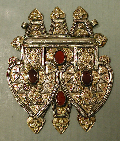 Double Cordiform Pendant, Silver; fire gilded, with applied decoration, stamping, decorative wire, ram's-head terminals, and table-cut and cabochon carnelians