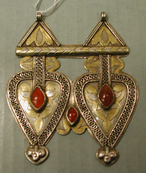 Double Cordiform Pendant, One of a Pair, Silver; fire-gilded and chased, with decorative wire, ram's-head terminals, embossed decoration, and cabochon carnelians 