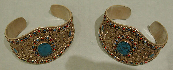 Armband, One of a Pair, Silver; with decorative wire whorl decoration, silver shot, table-cut
turquoises, and turquoise and coral beads