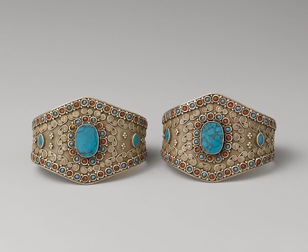 Armband, One of a Pair, Silver; with decorative wire whorl decoration, silver shot, table-cut
turquoises, and turquoise and coral beads 