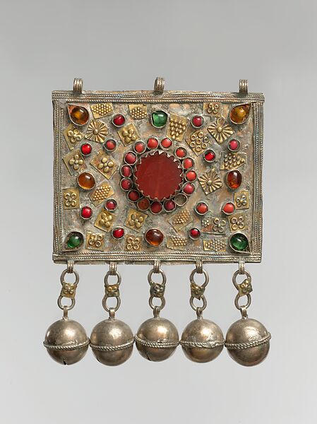 Front Panel of an Amulet Holder, Silver, with decorative wire, gilt applied decoration, chains, bells, table-cut carnelian, coral beads, and glass stones 