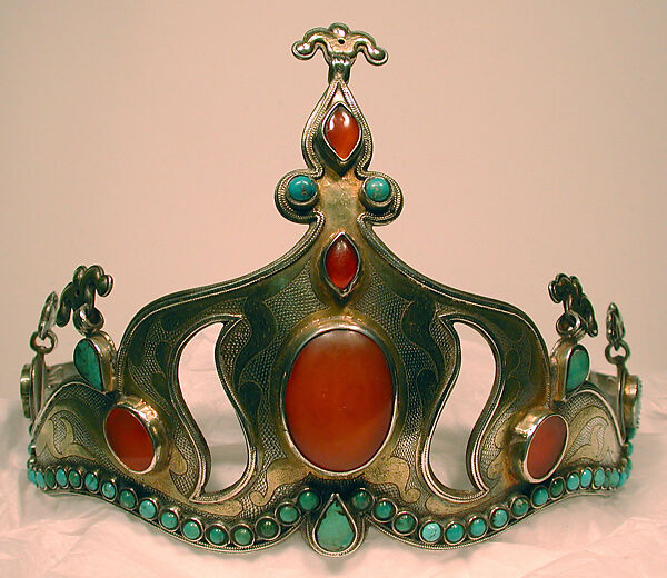 Crown, Silver; fire gilded with rams head upper terminations and engraved/punched with table cut and slightly domed carnelians and turquoises with twisted wire decorations