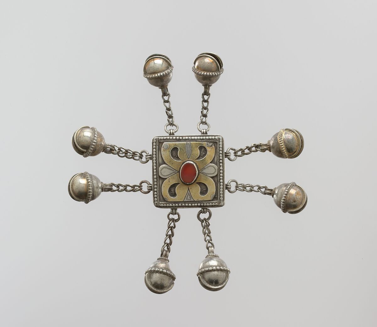 Amulet for Boy's Cap, Silver; fire-gilded and chased, with decorative wire, openwork, loop-in-loop chains, bells, and table-cut carnelian 