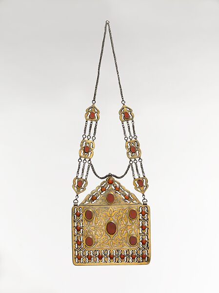 Amulet Holder, Silver; fire gilded with openwork and engraving/punching decoration and table cut carnelians and twisted silver wire chains 