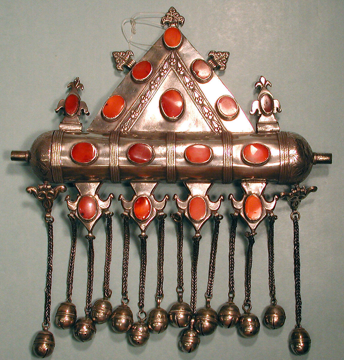Triangular Amulet Holder, Silver; with twisted wire chains and bells, chased and embossed decoration, and table-cut cut carnelians