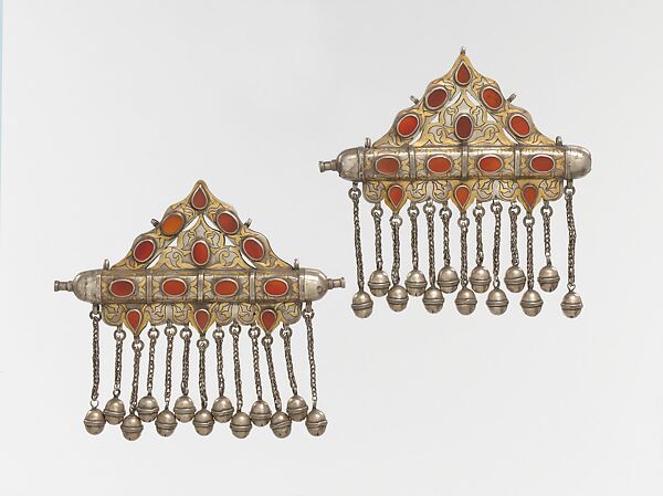Triangular Amulet Holder, One of a Pair, Silver, fire gilded and engraved/punched decoration and table cut carnelians, silver link chains and bells/beads. 