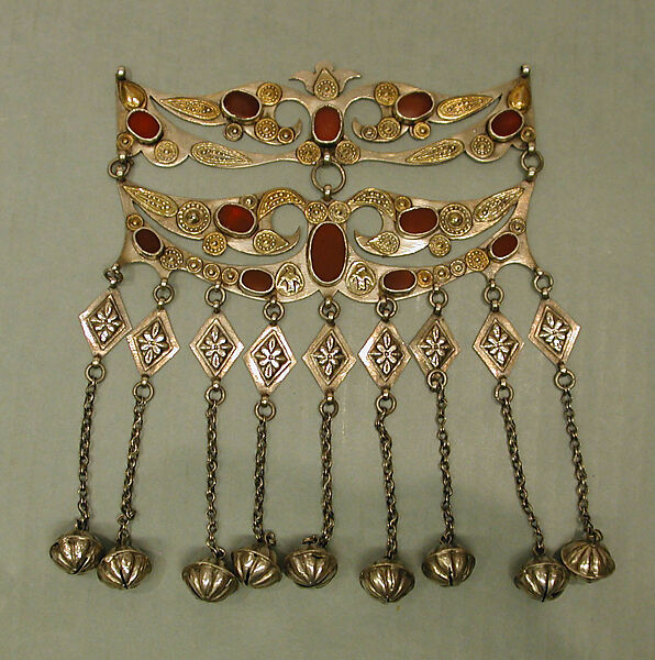 Dorsal Headdress Ornament, Silver with gilt applied decoration, embossed decoration, table cut carnelians, loop-in-loop chains, and bells