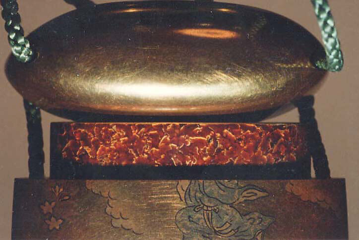 Inrō with the Queen Mother of the West (Seiōbo); Boy with a Peach (reverse), Four cases; lacquered wood with gold, silver, and color (iroko) togidashimaki-e on gold groundNetsuke: gold takamaki-e chrysanthemums (signed: Shigenori)Ojime: gold bead with chrysanthemum and butterflies in relief, Japan