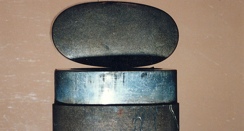 Case (Inrō) with Design of Court Lady in a Boat (obverse); Willow Tree (Asazuma) (reverse), Silver inlay with incised and applied gold decoration 
Ojime: silver bead 
Netsuke: bronze disk with metal inlay, Japan