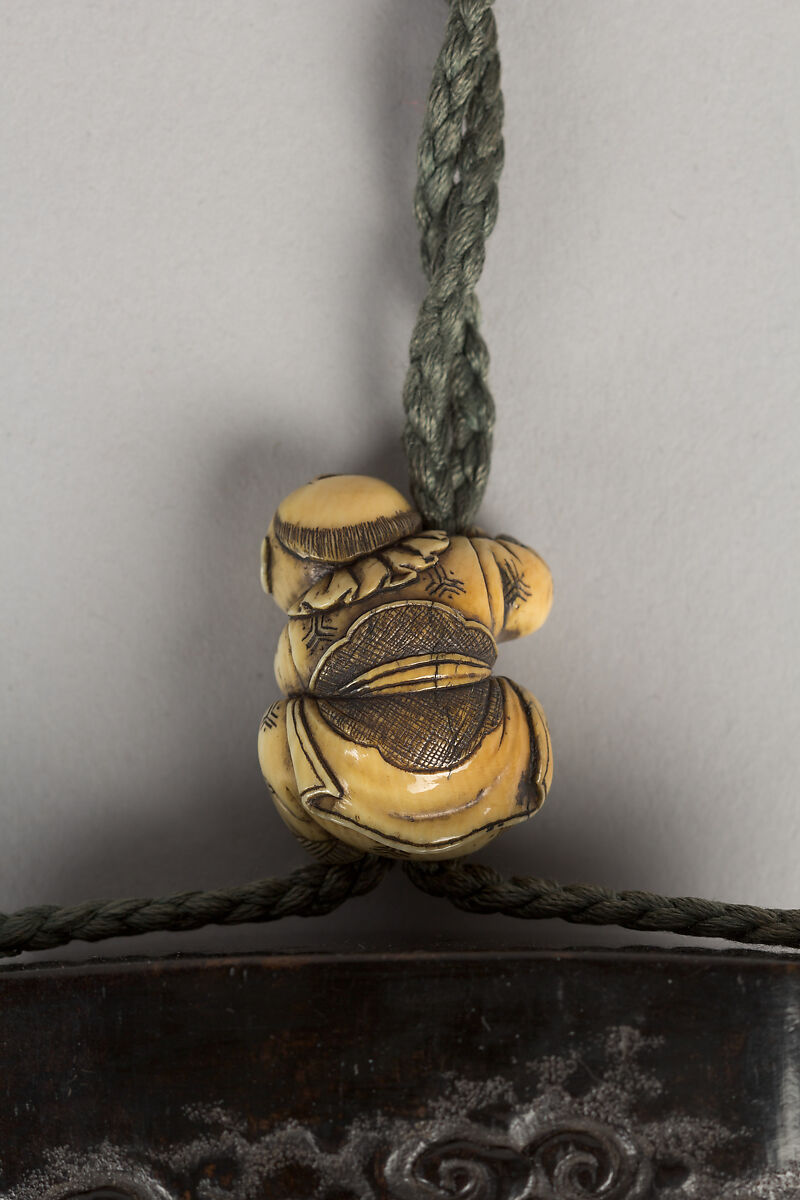 Case (Inrō) with Design of Ōni (Demon) Standing Behind Cloak of Arhat (obverse); Fly Whisk (Hossu) beneath Pine Tree (reverse), Tokoku, Wood ebony, carved relief with inlay of ivory, metal and malachite; Interior: plain;  Netsuke: Jurojin on crane; Ojime: Child climbing rope, Japan