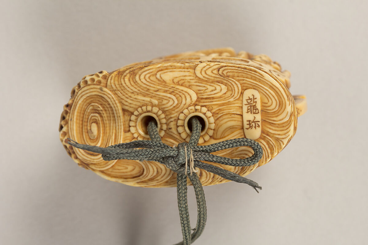 Inrō with the Noh Play Dōjōji (obverse) and Flowering Cherry Tree (reverse), Four cases; lacquered wood with gold, silver, color hiramaki-e, togidashimaki-e on gold ground
Netsuke: treasure ship with seven gods of good fortune; ivory
Ojime: wood bead, Japan