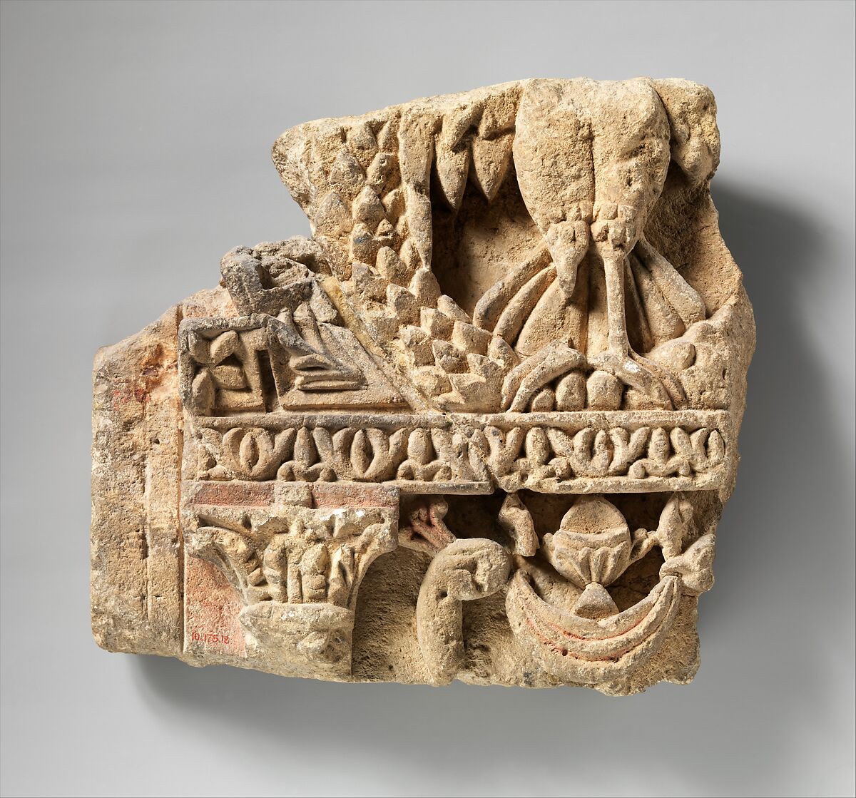 Fragment from a Two-Sided Sanctuary Screen with Birds Eating Grapes, Limestone, red pigment; carved in relief