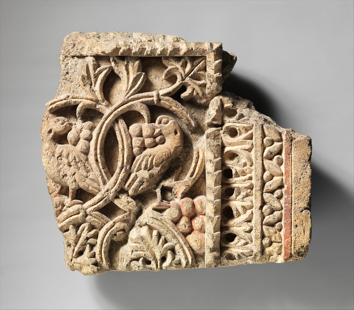Fragment from a Two-Sided Sanctuary Screen with Birds Eating Grapes, Limestone, red pigment; carved in relief 