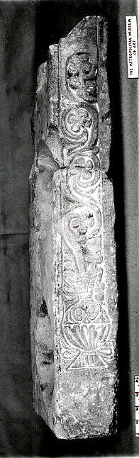 Fragment of a Stand for Water Jars Carved with a Vase and Vegetal Scroll, Limestone; carved in relief