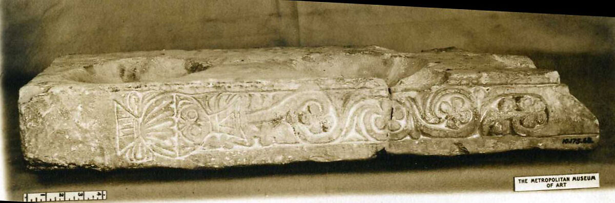 Fragment of a Stand for Water Jars Carved with a Vase and Vegetal Scroll, Limestone; carved in relief 