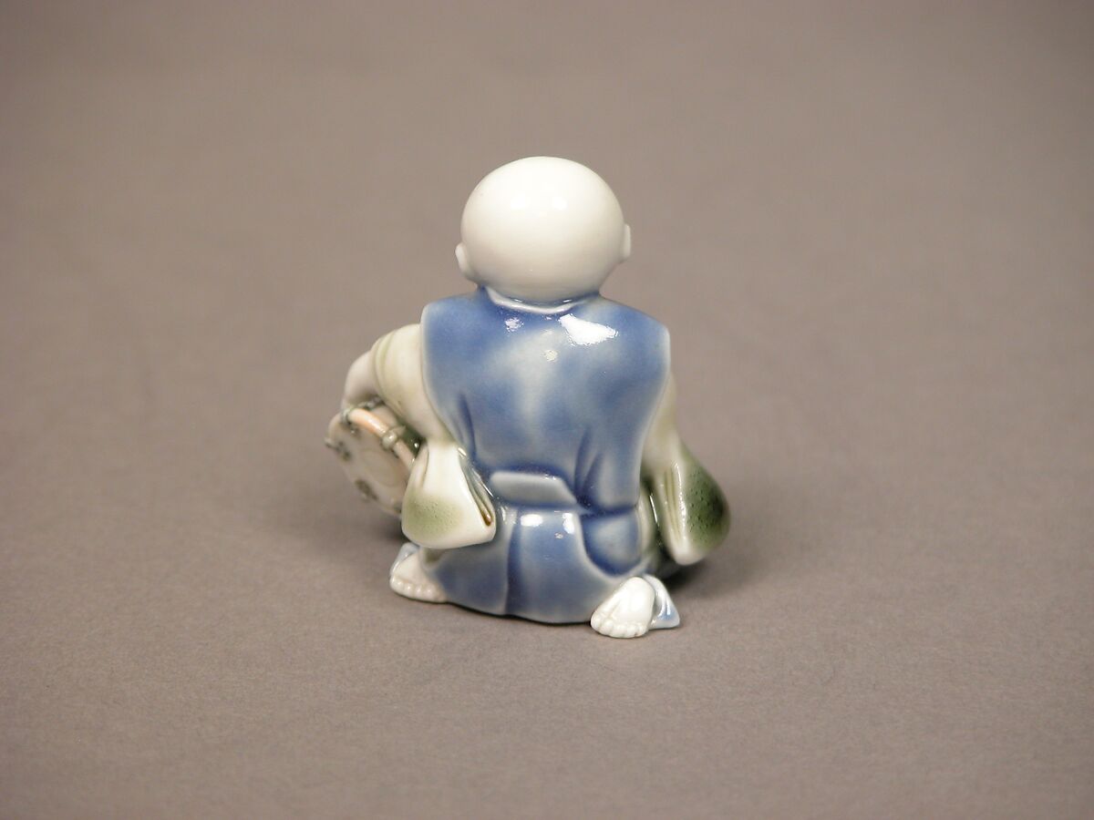 Chinese child with musical instrument, Porcelain with underglaze blue and iron decoration (Hirado ware), Japan