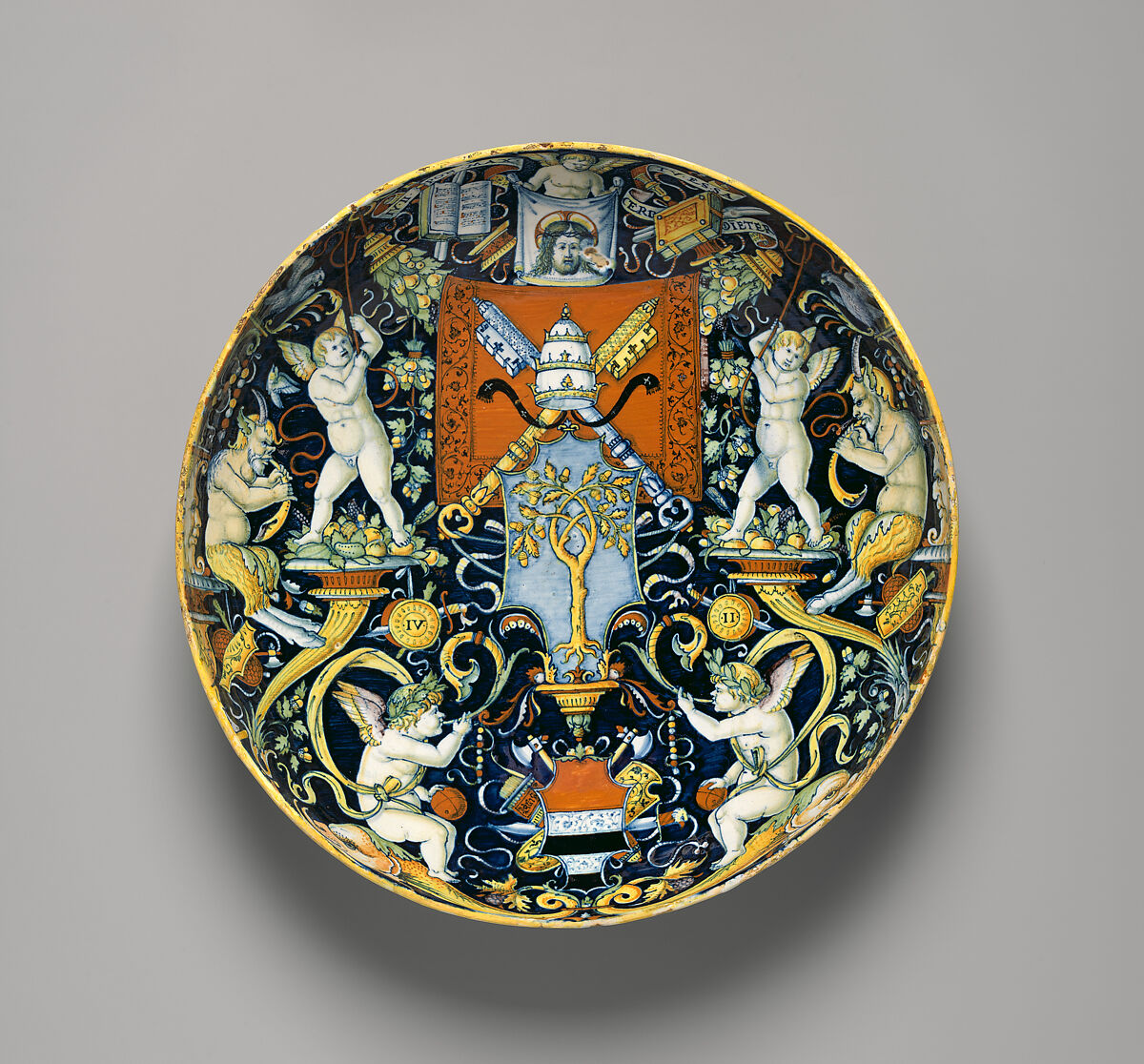 Bowl with the Arms of Pope Julius II and the Manzoli of Bologna surrounded by putti, cornucopiae, satyrs, dolphins, birds, etc., workshop of Giovanni Maria Vasaro, Maiolica (tin-glazed earthenware), Italian, Castel Durante