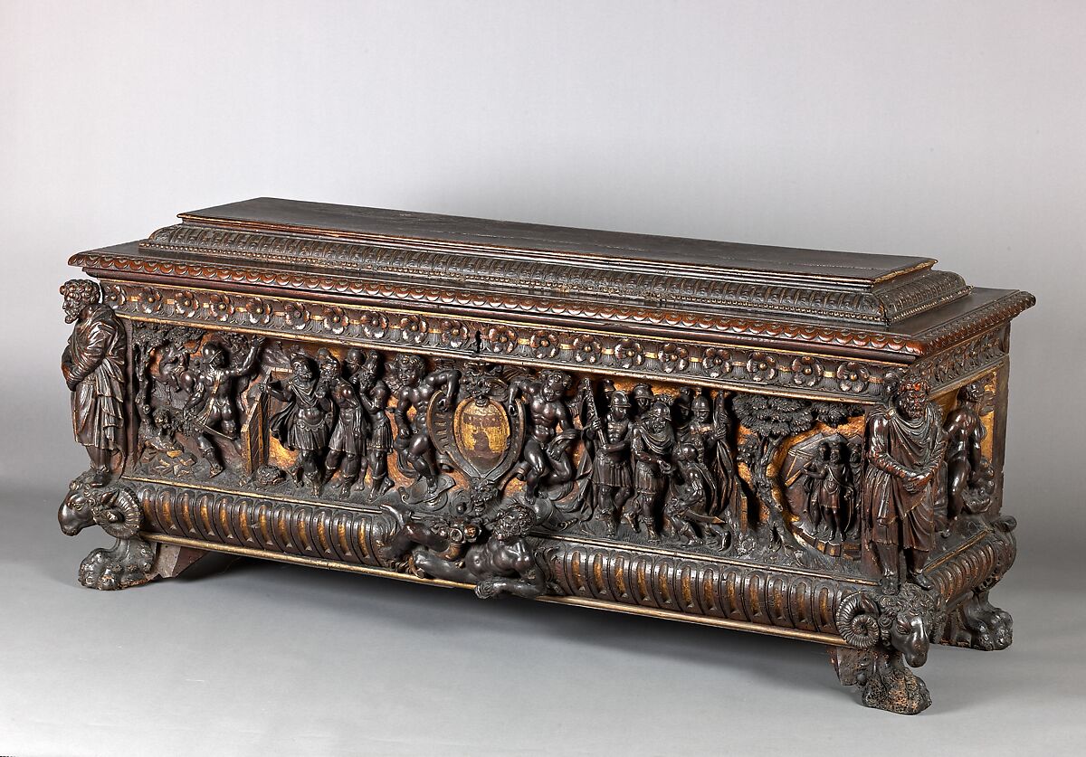 A Walnut, partially carved chest with traces of gilding and polychrome; shown with iron hardware. 