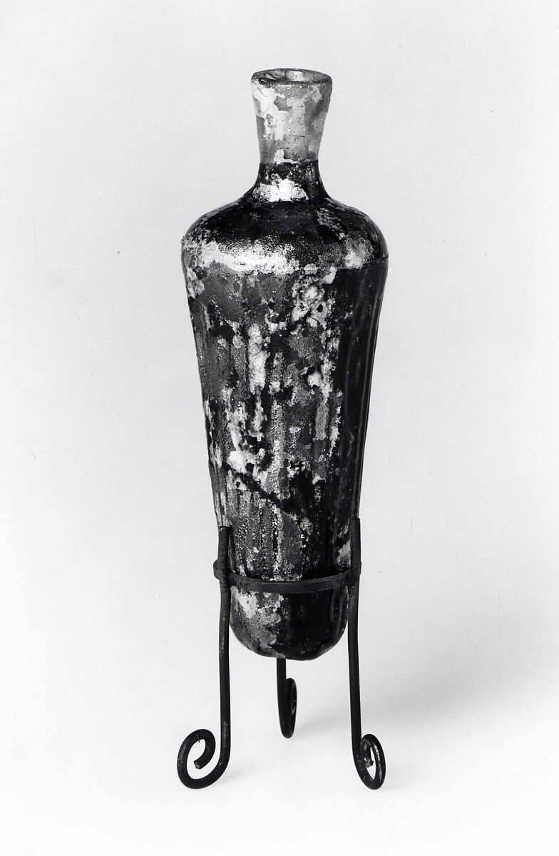 Flask, Almost colorless (brown tinged) and translucent purple glass. Blown (the body blown in a dip mold), the rim finished at the furnace, wheel-cut., Islamic 