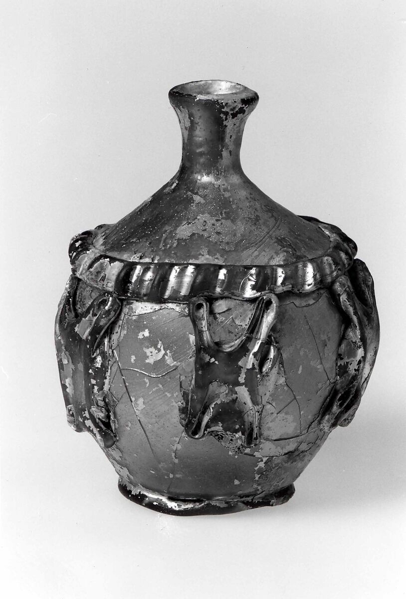 Flask, Probably almost colorless glass with a green or yellowish tint. Blown, the rim finished at the furnace, the decoration applied and tooled., Islamic 