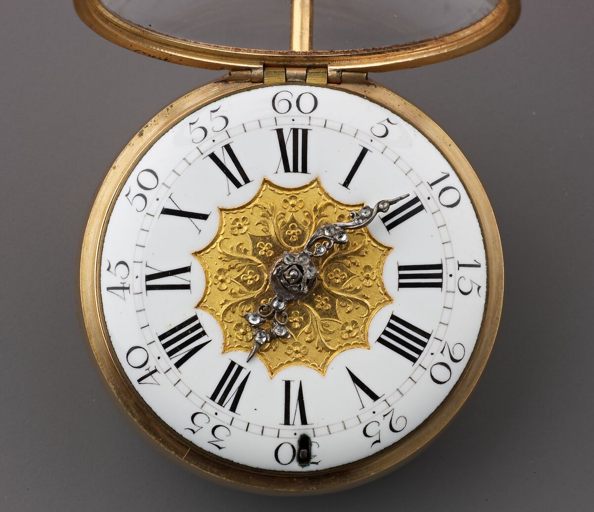 Watch Painted with a Pastoral Scene, Outer case of painted enamel on gold. Inner case of gold with an unidentified
maker’s mark consisting of the letters ic over b below a
coronet (incuse) on the interior and an eagle’s head, a French
guarantee mark for gold in use between 1 January 1847 and
1 July 1919 on the pendant. Dial of gold and white enamel
with black numerals; silver hands set with diamond chips.
Movement of gilt brass and steel. Movement signed (on the
back plate): Tomson/london., French and probably Swiss