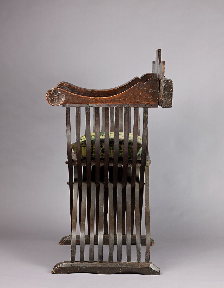 Folding armchair (sedia a Savonarola type), Walnut, partly turned and carved; green velvet., Italian