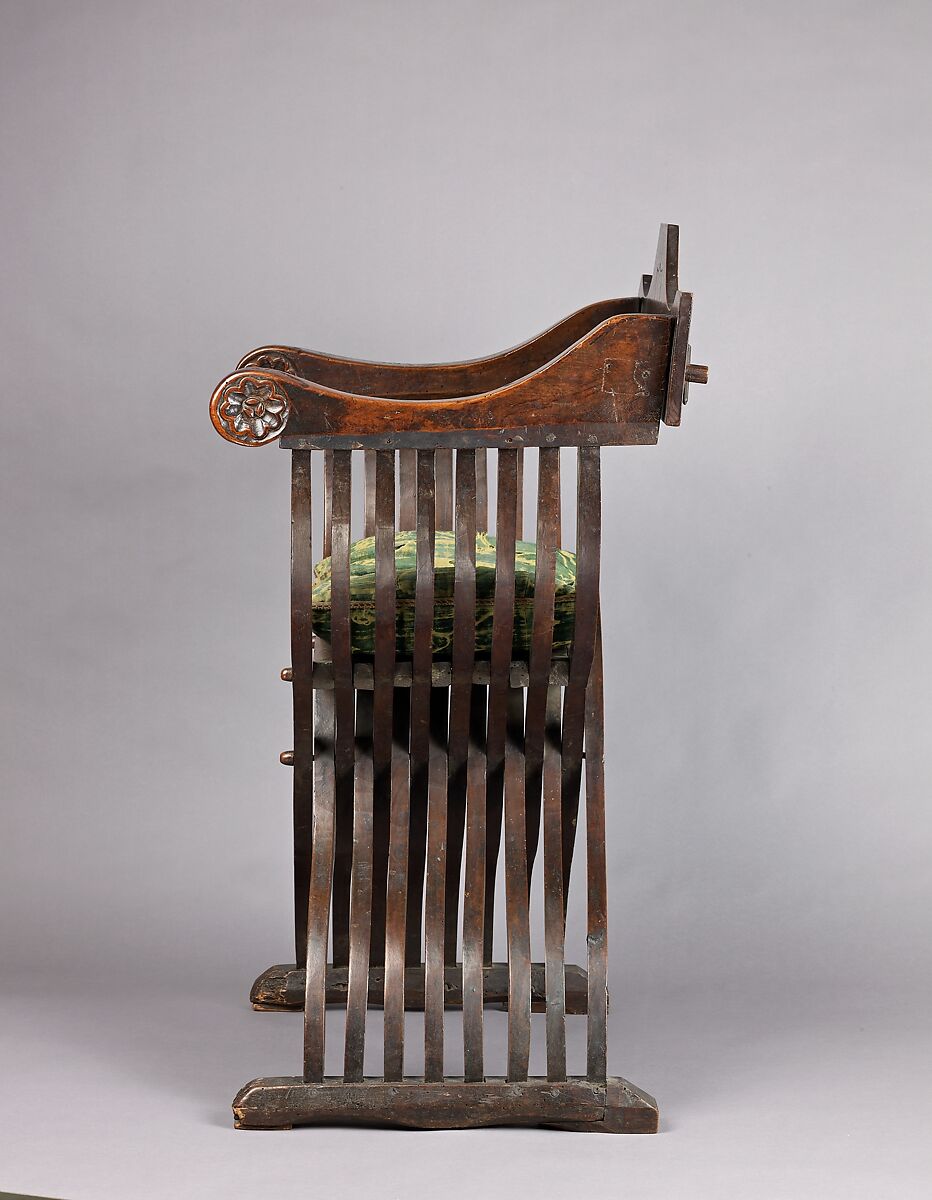 Folding armchair (sedia a Savonarola type), Walnut, partly turned and carved; green velvet., Italian