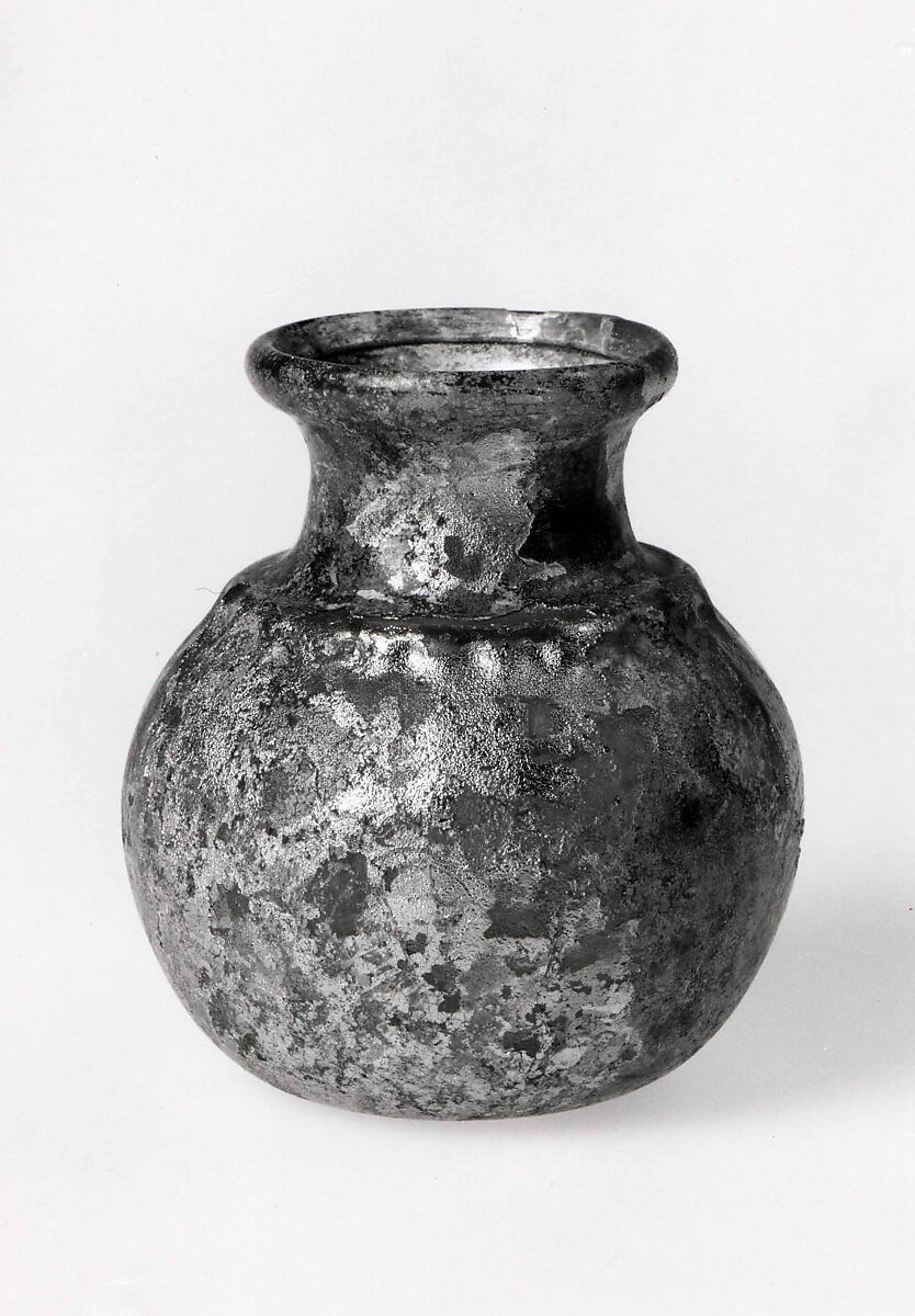 Jar, Apparently almost colorless glass with a brown or yellowish tint. Blown, the body inflated in a dip mold, the rim finished at the furnace., Roman 
