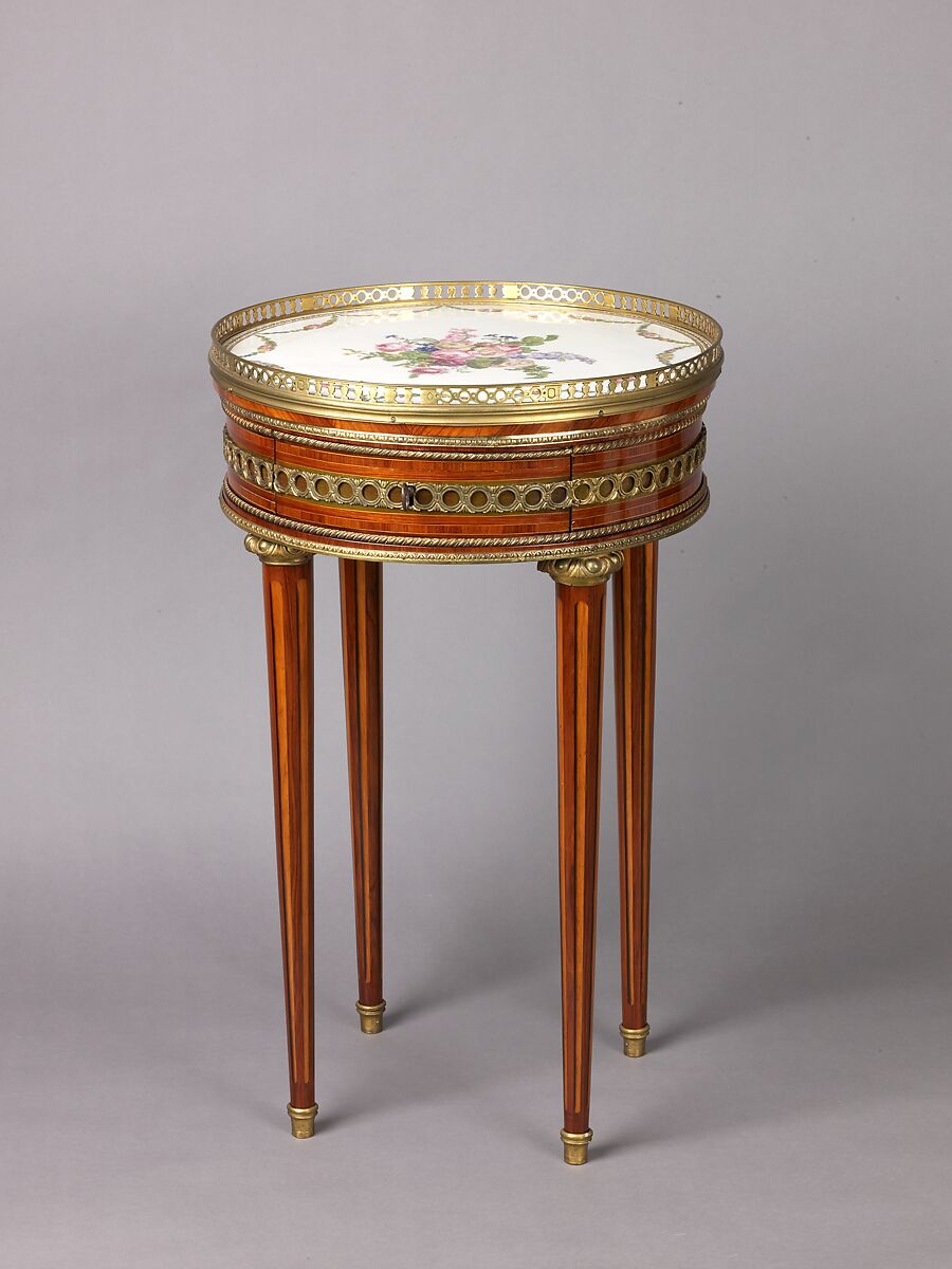 Louis XVI round table with sevres top, Oak veneered with tulipwood, rosewood, green-stained maple, holly stringing; legs veneered with rosewood and partly shaded satinwood; gilt-bronze mounts., French, Paris 