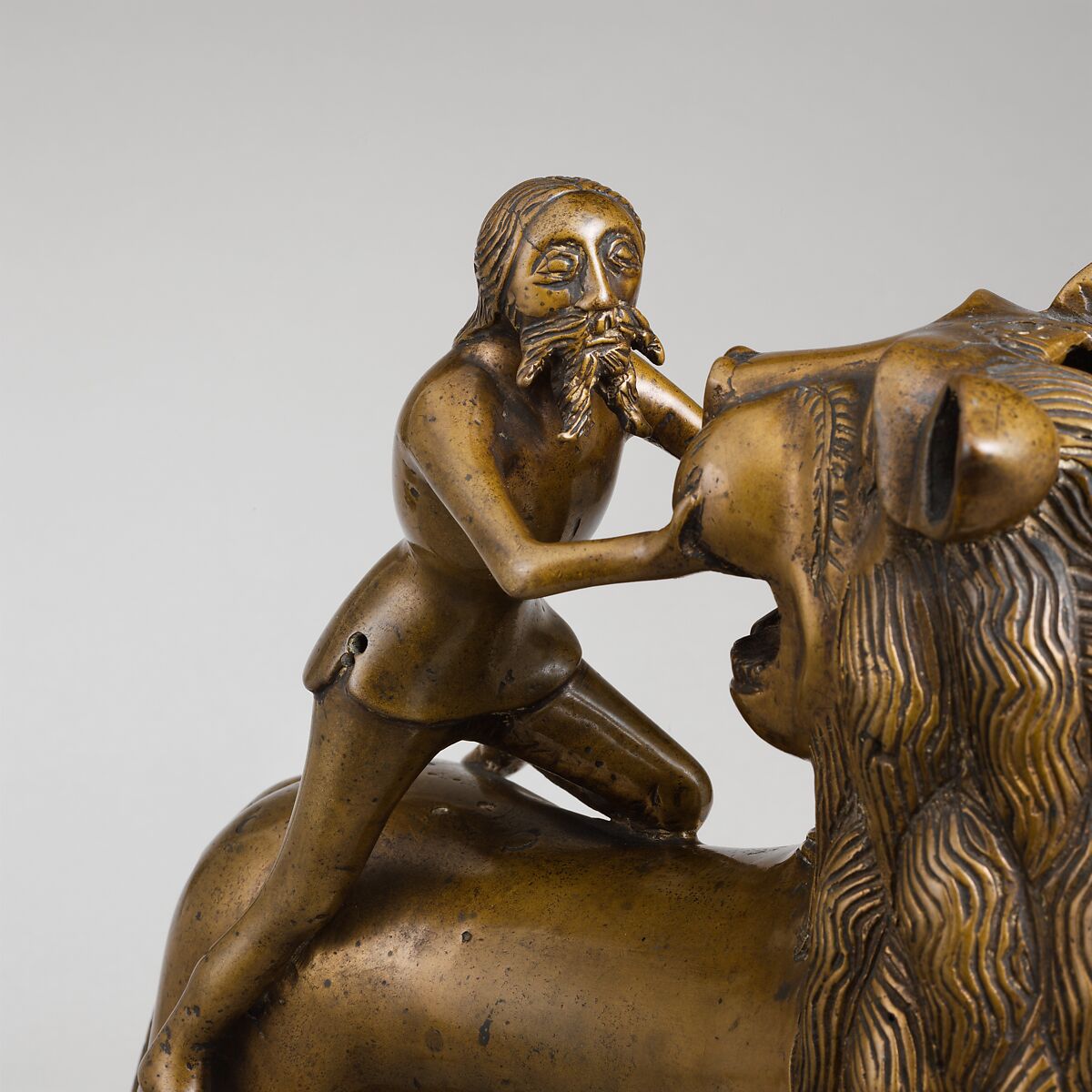 Aquamanile in the Form of Samson and
the Lion, Bronze; quaternary copper alloy (approx. 78% copper, approx. 10% zinc, approx. 6% tin, approx. 5% lead) with natural patina. Remnants of the iron armature are in the lion’s legs and the figure of Samson., Northern European (?), possibly German