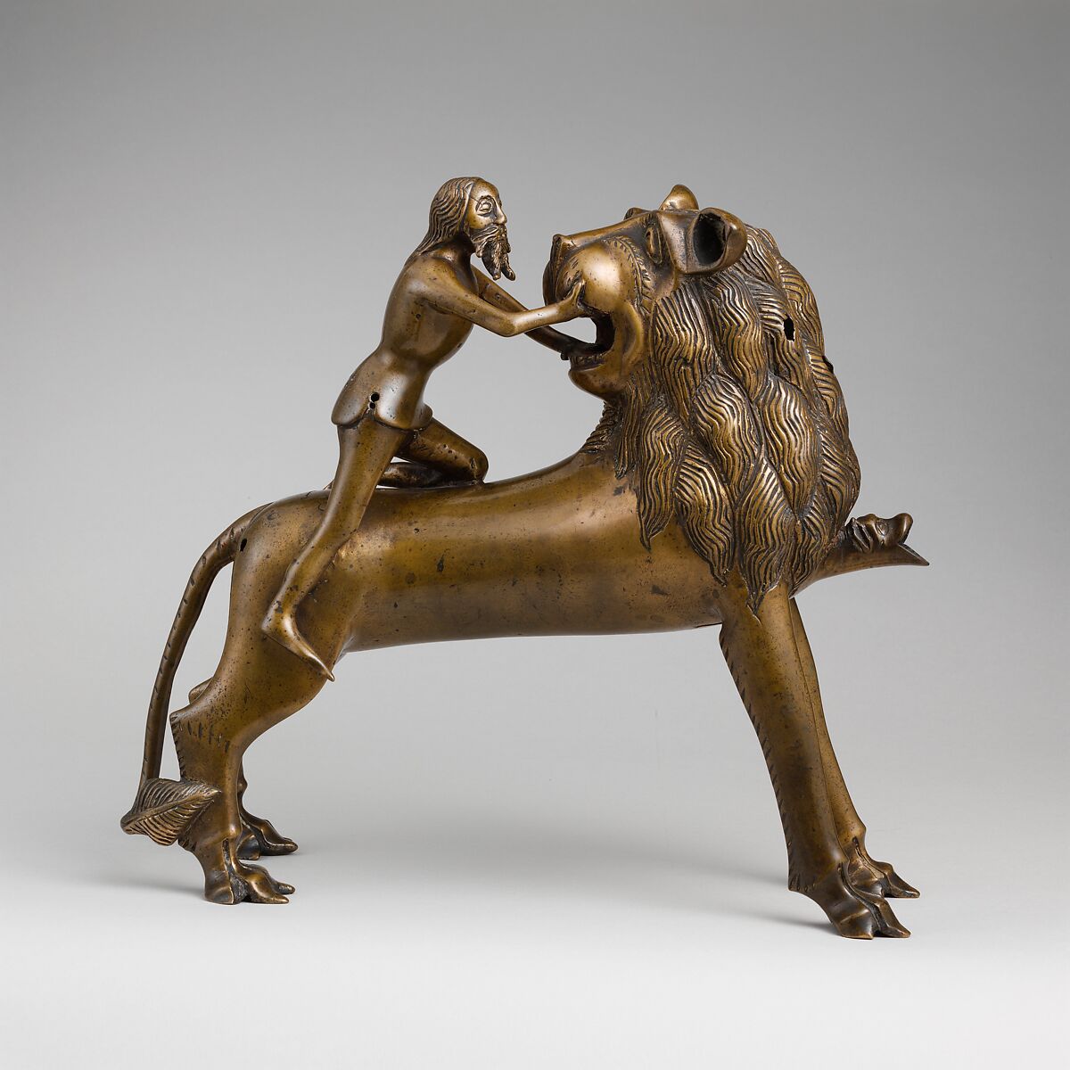 Aquamanile in the Form of Samson and
the Lion, Bronze; quaternary copper alloy (approx. 78% copper, approx. 10% zinc, approx. 6% tin, approx. 5% lead) with natural patina. Remnants of the iron armature are in the lion’s legs and the figure of Samson., Northern European (?), possibly German